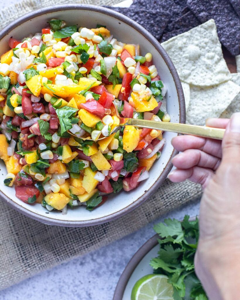 fresh peach salsa, spooning it out of the bowl