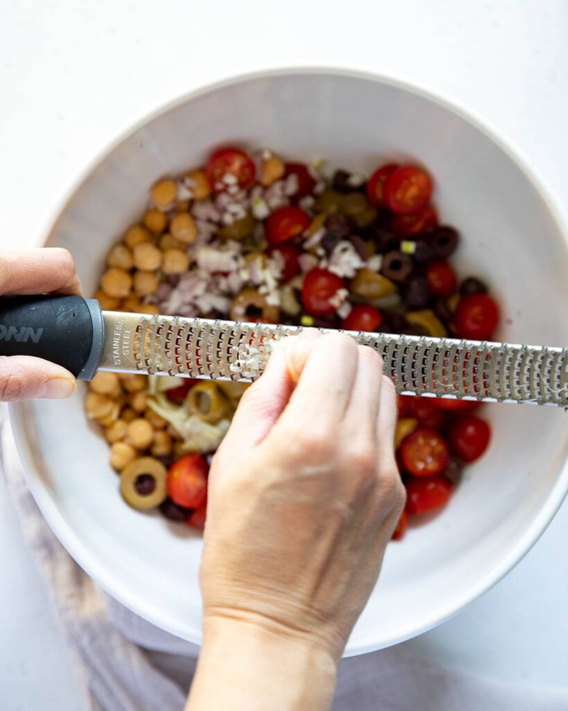 using a grater to grate garlic