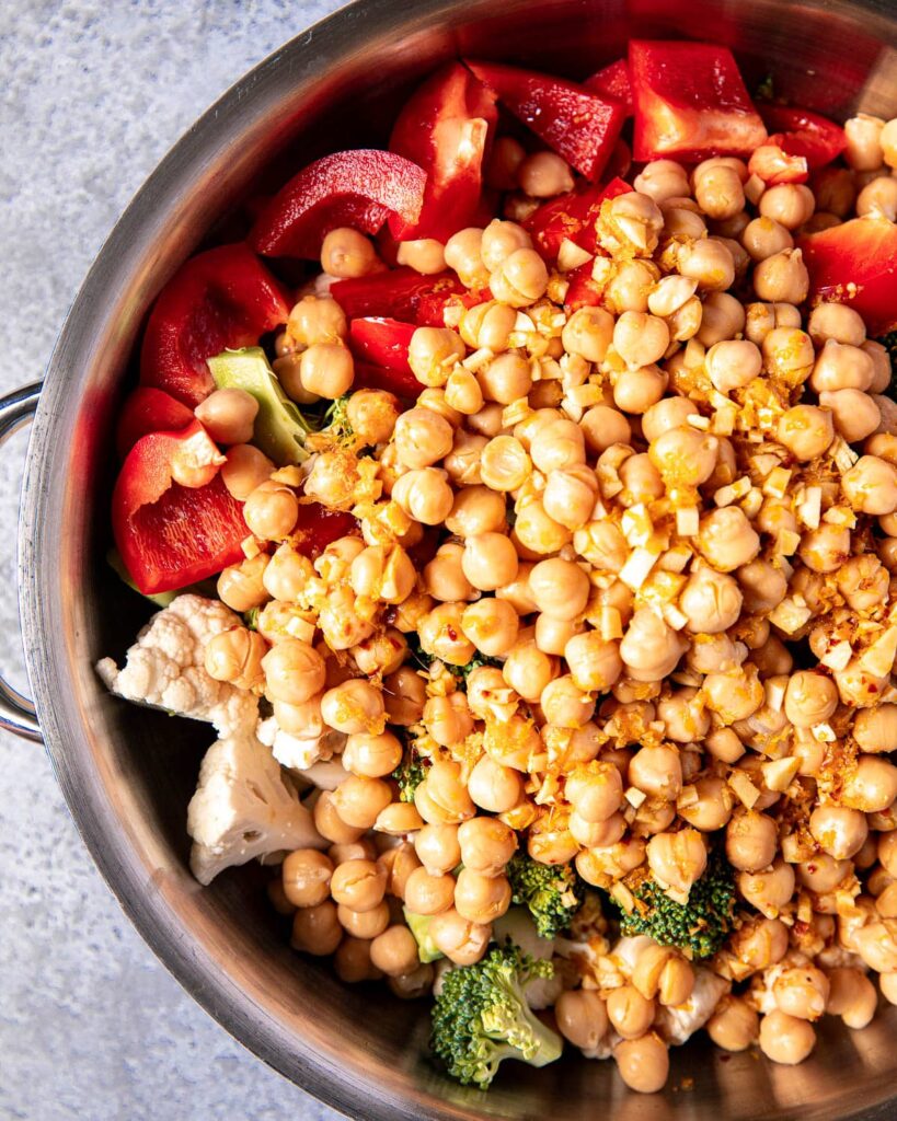 orange chickpeas and vegetables in pan