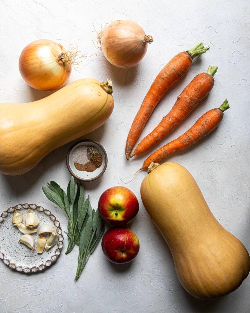 Butternut squash soup ingredients, butternut squash, carrots, onion, apple, sage, garlic and spices